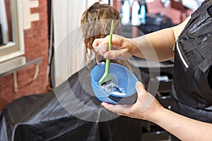 The Barber`s hands stir the hair dye photo