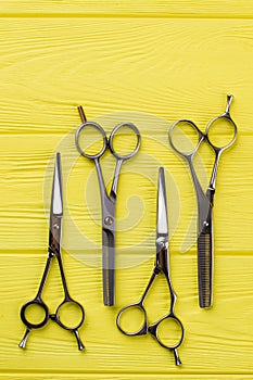 Barber scissors on color background.