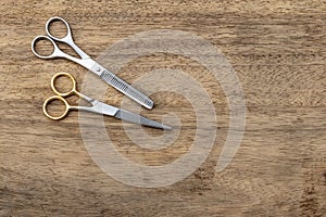 Barber scissors with copy space on wood background