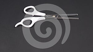Barber scissors isolated on black background