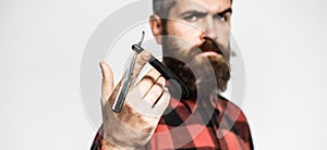 Barber scissors and straight razor, barbershop. Bearded man, long beard, brutal, caucasian hipster with moustache. Mens