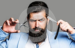 Barber scissors and straight razor, barber shop. Beard man, bearded male. Portrait beard man. Barber scissors and
