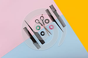 Barber set with combs and scissors on the color pink, yellow, blue paper background