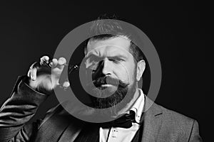 Barber shop. Hair style. Man with long beard holds steel scissors.