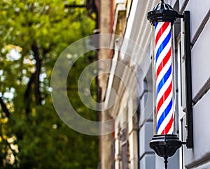 Barber shop pole. Logo of the barbershop, symbol. Barbershop pole, retro. Copy space. Old fashioned vintage barber shop