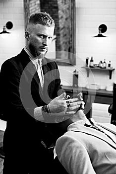 Barber shop tools on old wooden background with copy space. Bearded man getting haircut by hairdresser at barbershop. So