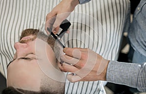 Barber smooths Clint`s beard photo