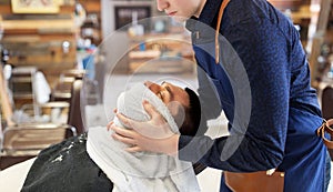 Barber softening male face sking with hot towel photo