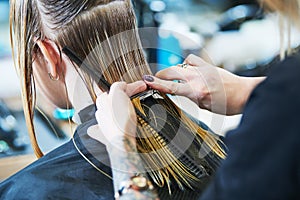 Barber or stylist at work. Hairdresser cutting woman hair