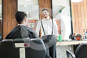 Barber Talking To Customer While Asking About His Preferences