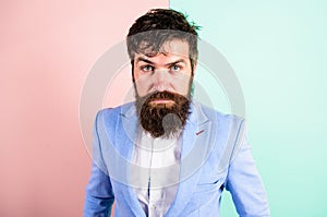 Barber tips grooming beard. Man bearded hipster on strict face pink blue background. Hipster guy with messy tousled hair