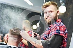 Barber at work. Hairdresser cutting hair of client