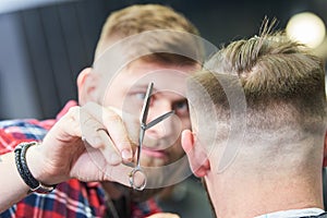 Barber at work. Hairdresser cutting hair of client