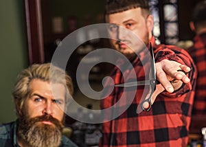 Barber works on hairstyle for bearded man barbershop background. Barber and hair stylist dedicate to making you better