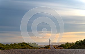 Solitary Lighthouse Road at Sunset, Formentera with Silky Clouds and Sea photo