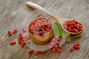 Barberries and goji berries on wooden background