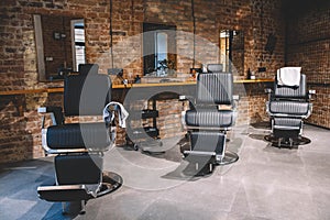 Barbershop armchair, barber shop for men. Empty chairs in retro styled barbershop. Hair salon interior. Place for text or