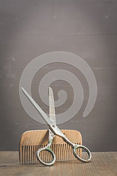 Barbershop concept. Old style. Hairbrushes and a scissors on a gray background. Selective focus