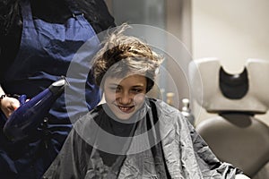 barbershop dries the hair of a teenager