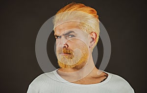 Barbershop, dyed hair and beard. Man beardcare and haircare. Serious bearded man portrait. Young guy.