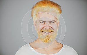 Barbershop, dyed hair. Man beard care and hair care. Portrait of serious bearded man. Smiling young guy.