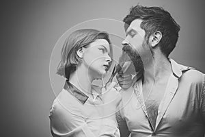 Barbershop or hairdresser concept. Woman hairdresser cuts beard with scissors. Man with long beard, mustache and stylish