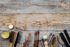 Barbershop. Men`s shaving and haircut. Brush, razor, comb, sciccors on wooden table background top view copyspace