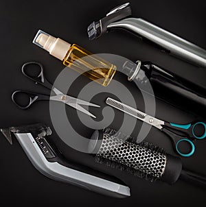 Barbershop tools on a black background for haircuts and hairstyles. Razor. Scissors. Hair oil. Hair spray. round brush brush.