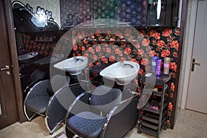 Barbershop washbasin with professional chairs . Interior view of luxury beauty salon . hairdresser washbasins