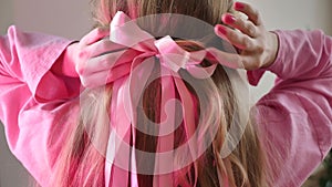 Barbie hairstyle with a pink bow