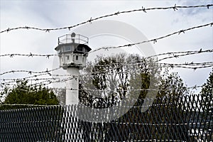 Barbwire,, watchtower and  wire netting fence  - Symbols of loss of freedom, capitivity and demarcation