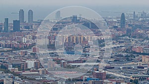 Barcelona and Badalona skyline with roofs of houses and sea on the horizon at evening