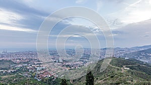 Barcelona and Badalona skyline with roofs of houses and sea on the horizon at evening timelapse