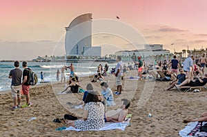 Barcelona beach with tourists at sunset