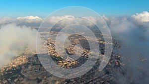 Barcelona City above the clouds and fog, Eixample residential famous urban grid