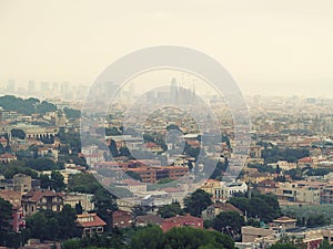 Barcelona panorama with the silhouette of the Sagrada Familia on the horizon on a cloudy foggy day. Beautiful urban landscape of