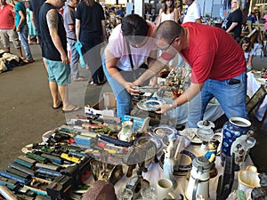 Barcelona, Spain - August 21, 2016: Visitors inspect examine various range of retro goods merchandise on flea market