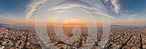 Barcelona, Spain - Feb 25, 2020: Aerial panorama shot of Barcelona coastline sun rising over horizon in winter morning