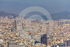 Barcelona, Spain - February 22, 2019 - La Sagrada Familia cathedral as viewed from Monjuic Castle. It is a famous landmark in the