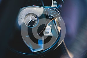 Barcelona, Spain - July 24, 2021: The Mercedes Benz interior detail of steering wheel, airbag, and horn. Illustration of car