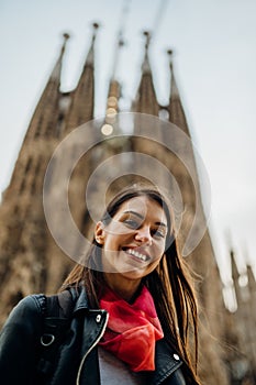 BARCELONA,SPAIN-March 12 : Smiling spanish woman visiting famous landmarks and attractions,gothic church Sagrada Familia,in center photo