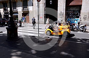 Two-seater electric car with quick learning handlebars for rent when visiting the city.