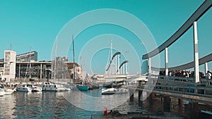 Barcelona, Spain - October, 2022: View of Port Vell Rambla del mar in Barcelona. Many boats in the port. Modern