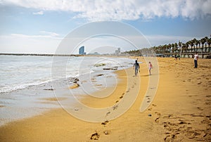 BARCELONA, SPAIN - OCTOBER 15, 2018: Surfer walking on the Barcelona beach. Summer vacations travel. Men is taking a photo