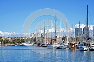 Barcelona, Spain: View from Rambla de Mar to the waterfront of Port Vell in Barcelona on a sunny day. Seagulls against