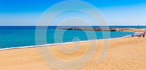 Barceloneta beach in Barcelona. Nice sand beach with palms. Sunny bright day with blue sky. Famous tourist destination in