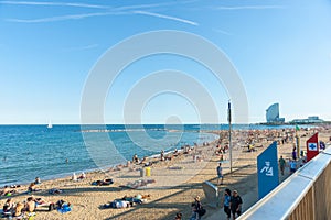 Barcelonetta Beach with architecturally modern W Hotel in distance, sunbathers along sandy beach Barcelona Spain