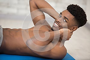 bare chested man doing sit-ups photo