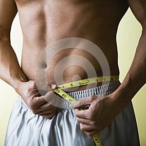 Bare Chested Man Measuring Wai