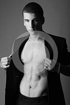 Bare chested man wearing suit photo